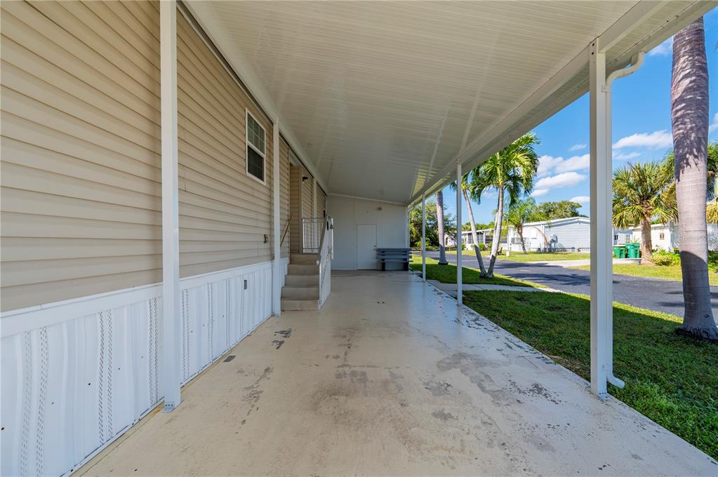 24437 Harbor View Road, Unit 51 Punta Gorda, FL 33980 - Photo 13 of 61 a view of a house with backyard and a trees