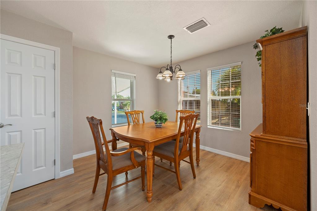 24437 Harbor View Road, Unit 51 Punta Gorda, FL 33980 - Photo 23 of 61 a view of a dining room with furniture window and wooden floor