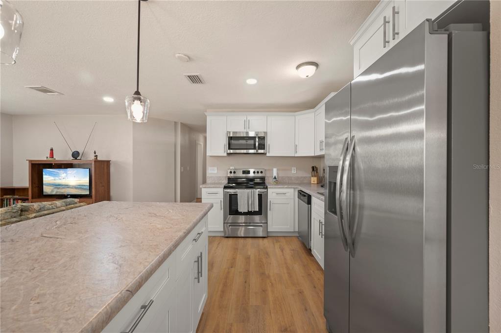 24437 Harbor View Road, Unit 51 Punta Gorda, FL 33980 - Photo 24 of 61 a kitchen with a refrigerator a sink and dishwasher