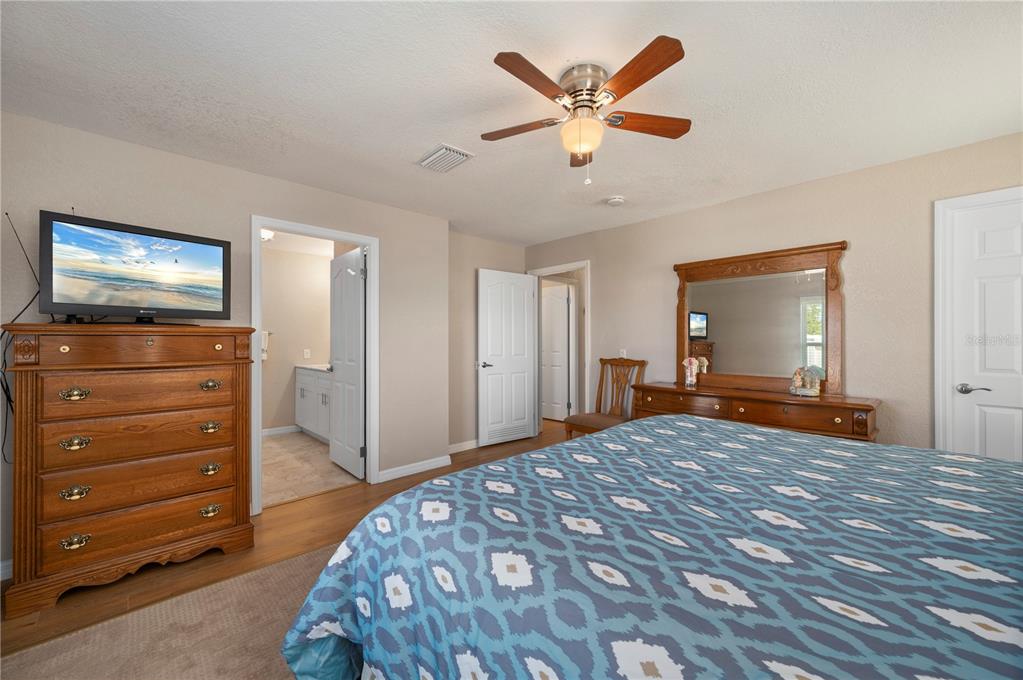24437 Harbor View Road, Unit 51 Punta Gorda, FL 33980 - Photo 29 of 61 a bedroom with a bed and a flat screen tv