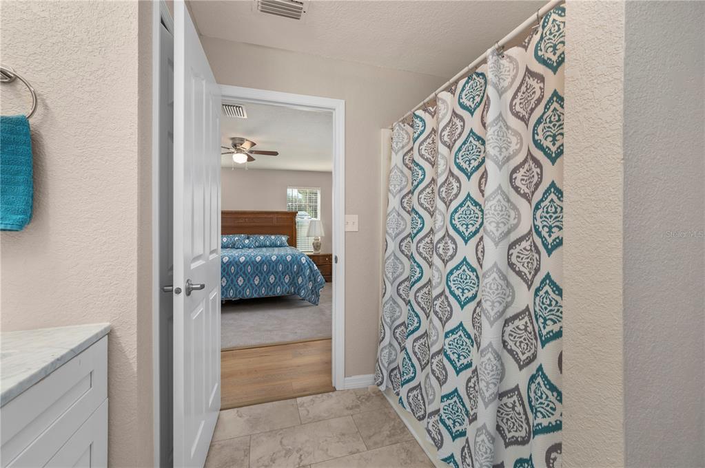 24437 Harbor View Road, Unit 51 Punta Gorda, FL 33980 - Photo 30 of 61 a bedroom with a bed and a view of bathroom