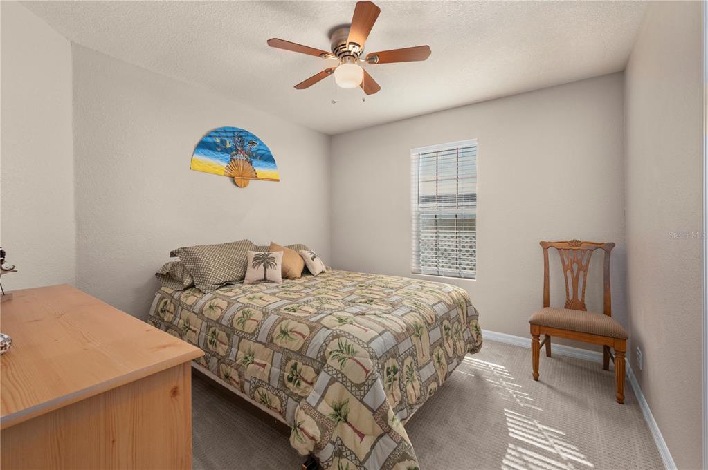 24437 Harbor View Road, Unit 51 Punta Gorda, FL 33980 - Photo 31 of 61 a bedroom with a bed and a chandelier