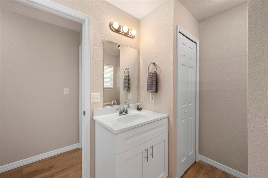 24437 Harbor View Road, Unit 51 Punta Gorda, FL 33980 - Photo 32 of 61 a bathroom with a sink a mirror and a vanity