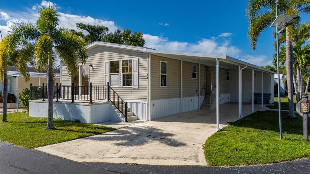 24437 Harbor View Road, Unit 51 Punta Gorda, FL 33980 - Photo 35 of 61 a front view of a house with a yard