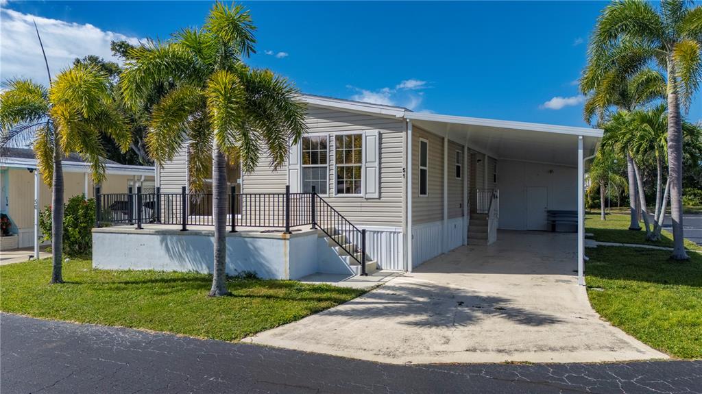 24437 Harbor View Road, Unit 51 Punta Gorda, FL 33980 - Photo 36 of 61 a front view of a house with a yard and porch