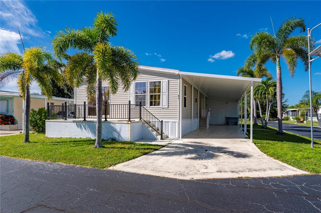 24437 Harbor View Road, Unit 51 Punta Gorda, FL 33980 - Photo 7 of 61 a house with palm tree in front of it