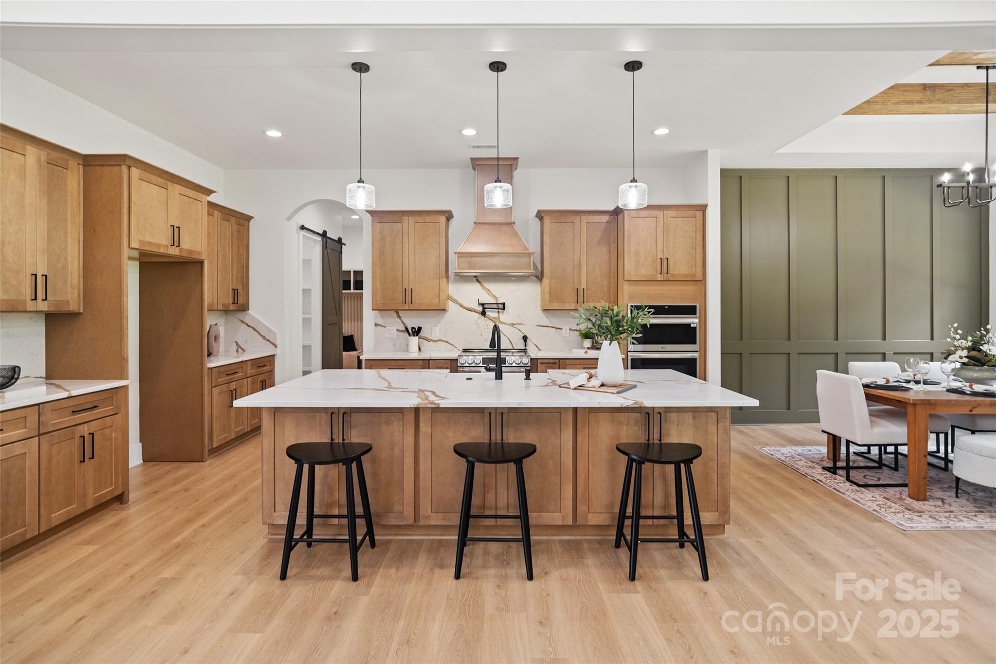 5015 Lancaster Highway Monroe, NC 28112 - Photo 31 of 46 a kitchen with stainless steel appliances a dining table chairs and wooden floor