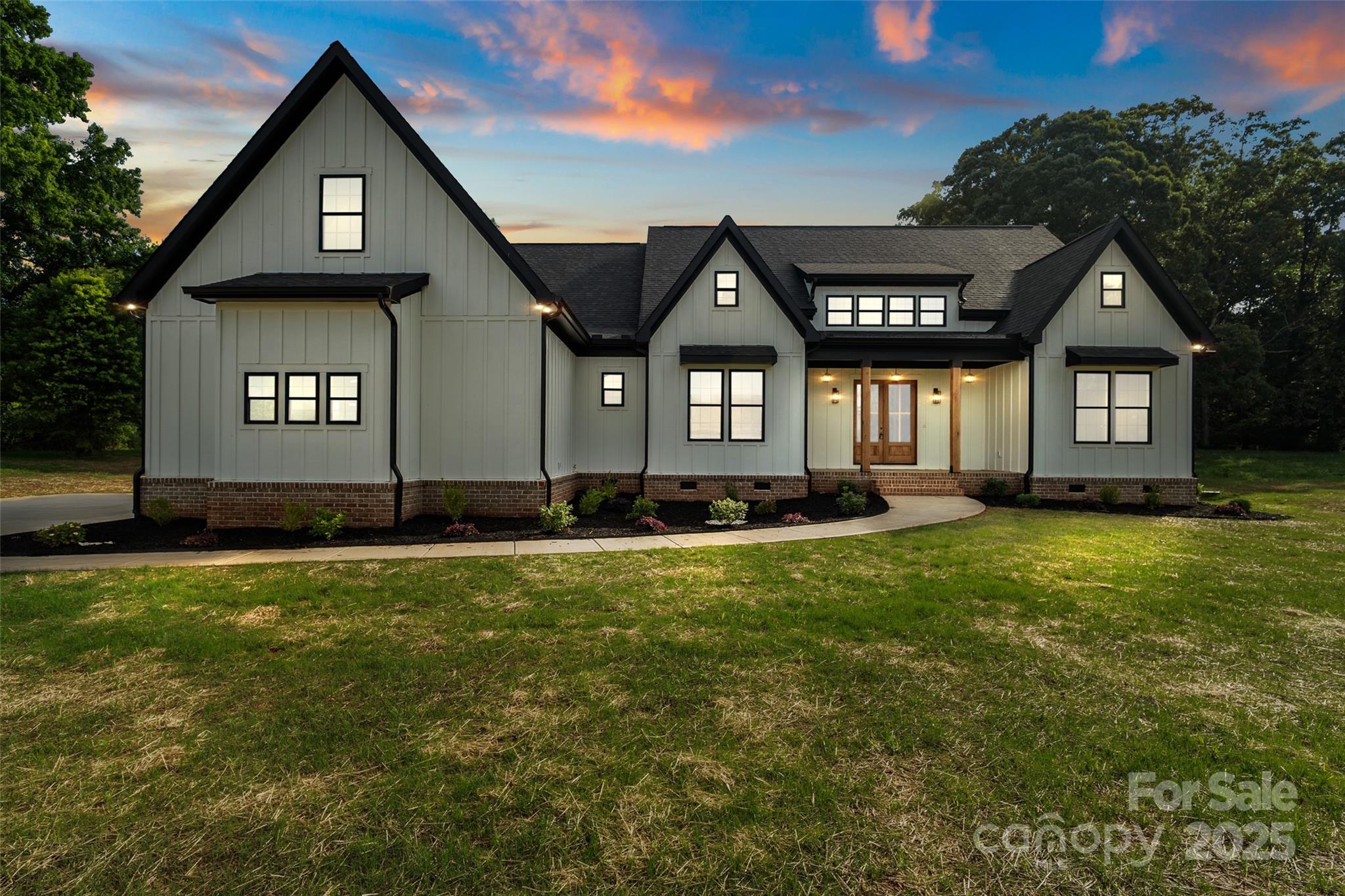 5015 Lancaster Highway Monroe, NC 28112 - Photo 7 of 46 a front view of a house with a yard and garage