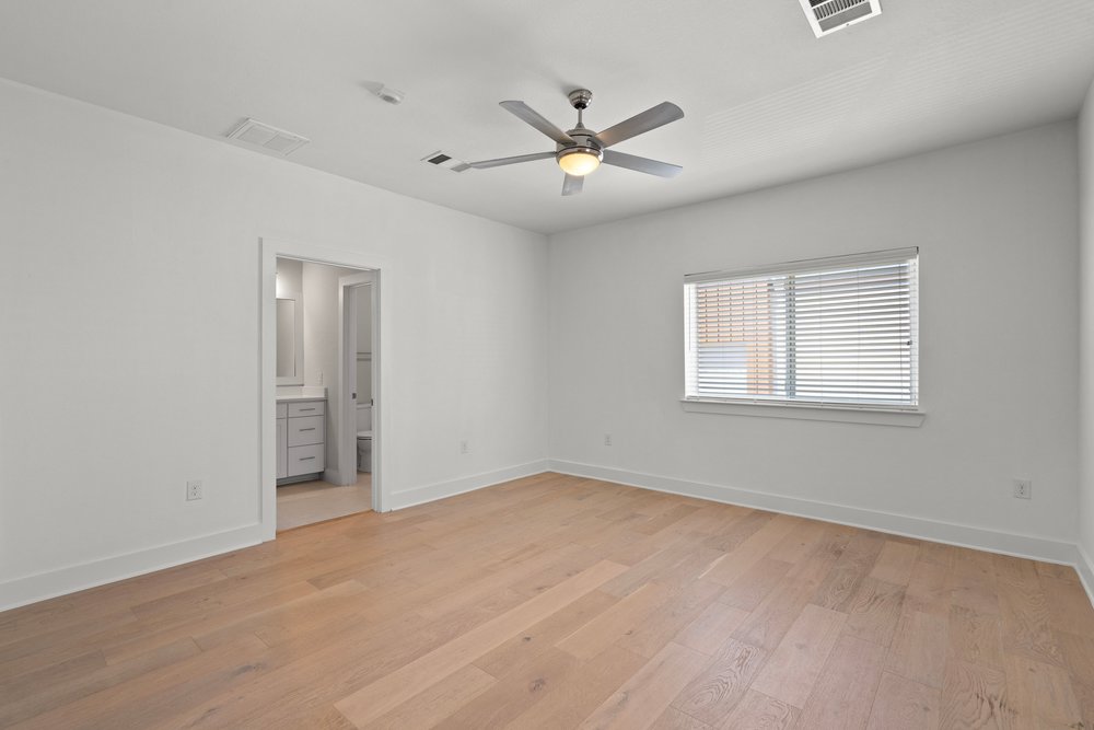 2827 Manor Road, Unit 2201 Austin, TX 78722 - Photo 35 of 40 Spacious room featuring wood-finish flooring, a contemporary ceiling fan, and a window with blinds