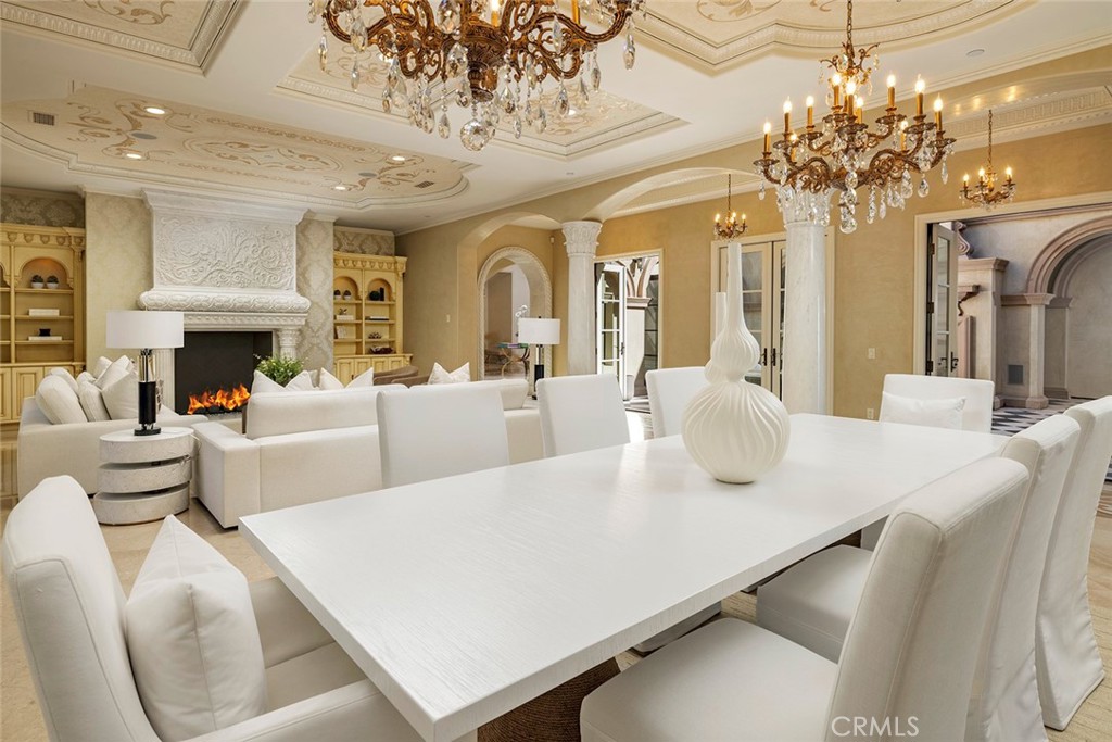 26 Deep Sea Newport Coast, CA 92657 - Photo 11 of 50 a living room with fireplace furniture and a chandelier