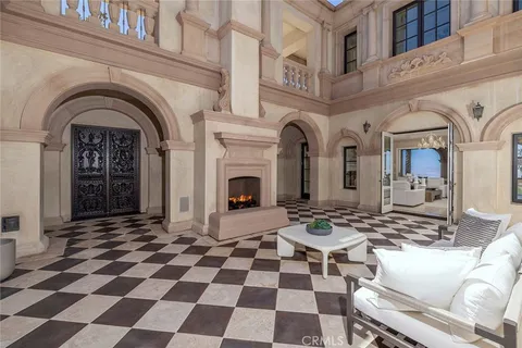 a living room with furniture and a large mirror