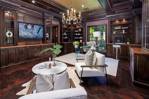 a view of a dining room with furniture a chandelier and wooden floor