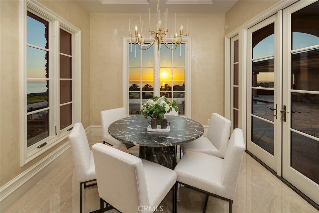 26 Deep Sea Newport Coast, CA 92657 - Photo 17 of 50 a dining room with furniture and chandelier