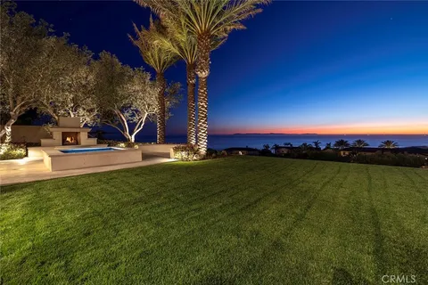 a view of a swimming pool with a yard and sitting area