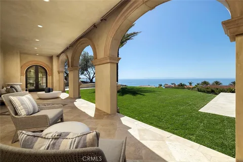 a living room with furniture a fireplace and a chandelier
