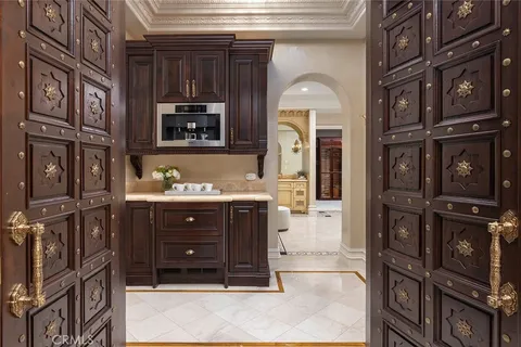 a room with a refrigerator and wooden floor