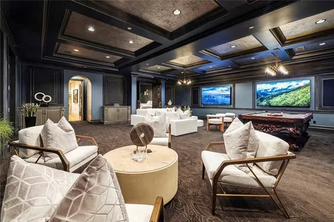 a living room with patio furniture and a flat screen tv