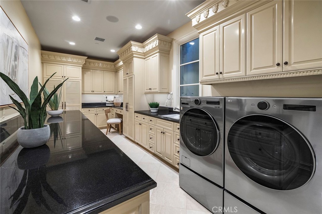 26 Deep Sea Newport Coast, CA 92657 - Photo 36 of 50 a kitchen with stainless steel appliances granite countertop a sink a stove and cabinets