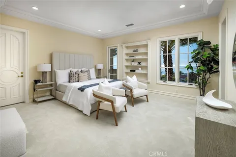 a bedroom with a bed couch and window