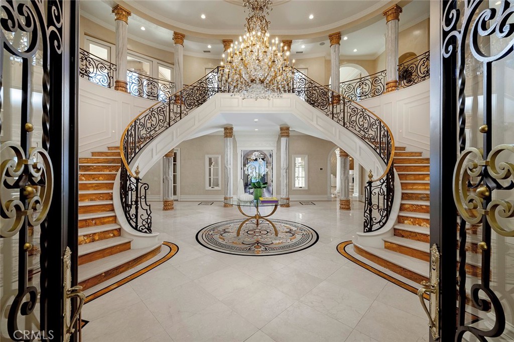 26 Deep Sea Newport Coast, CA 92657 - Photo 5 of 50 a view of a hallway with dining table and chandelier