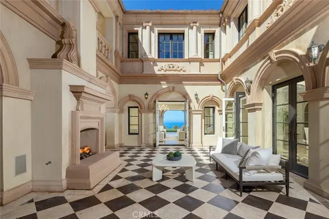 a living room with patio furniture and a fireplace