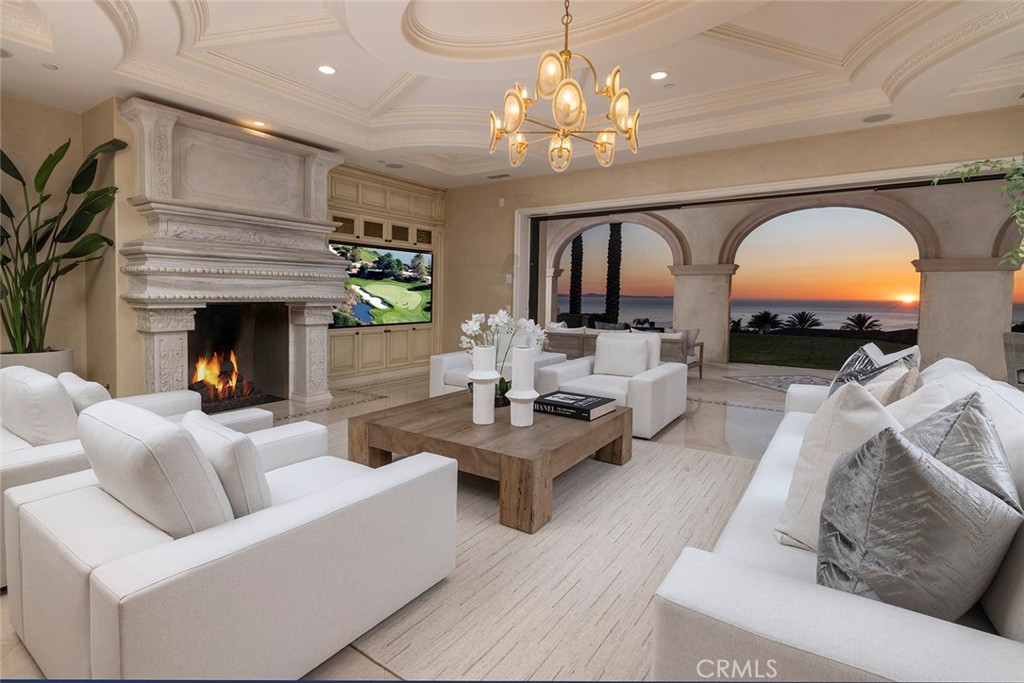 26 Deep Sea Newport Coast, CA 92657 - Photo 8 of 50 a living room with furniture a fireplace and a chandelier