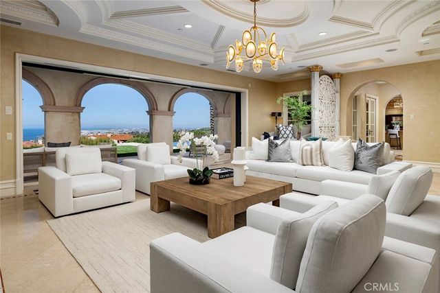 a living room with fireplace furniture and a chandelier