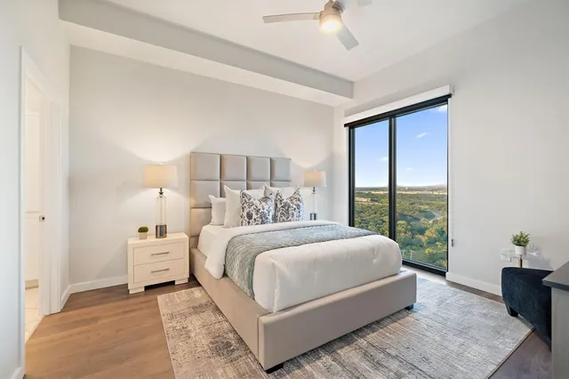 a spacious bathroom with a granite countertop sink a mirror a bathtub and a shower