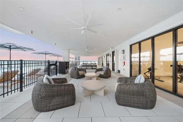 a living room with furniture and a floor to ceiling window