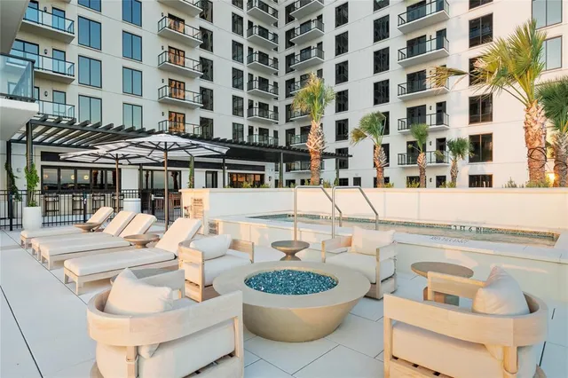 a building outdoor space with patio furniture and potted plants