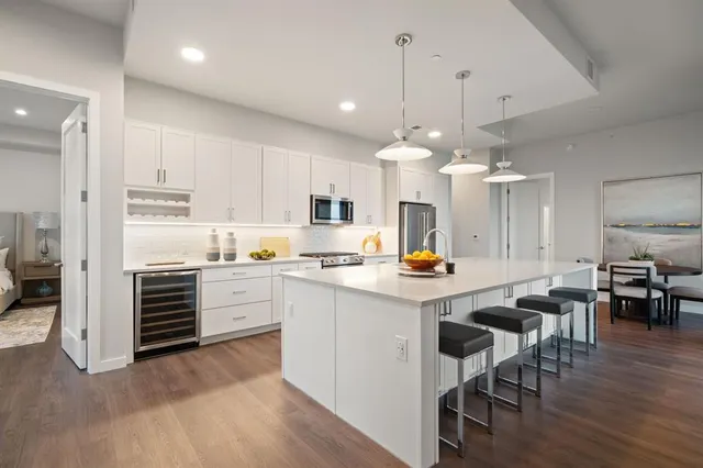 a large white kitchen with a large window