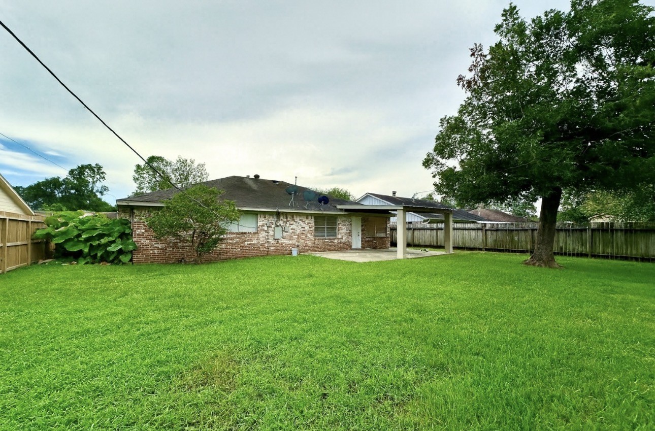9811 Mango Street Houston, TX 77075 - Photo 14 of 14 a view of a big house with a big yard and large trees