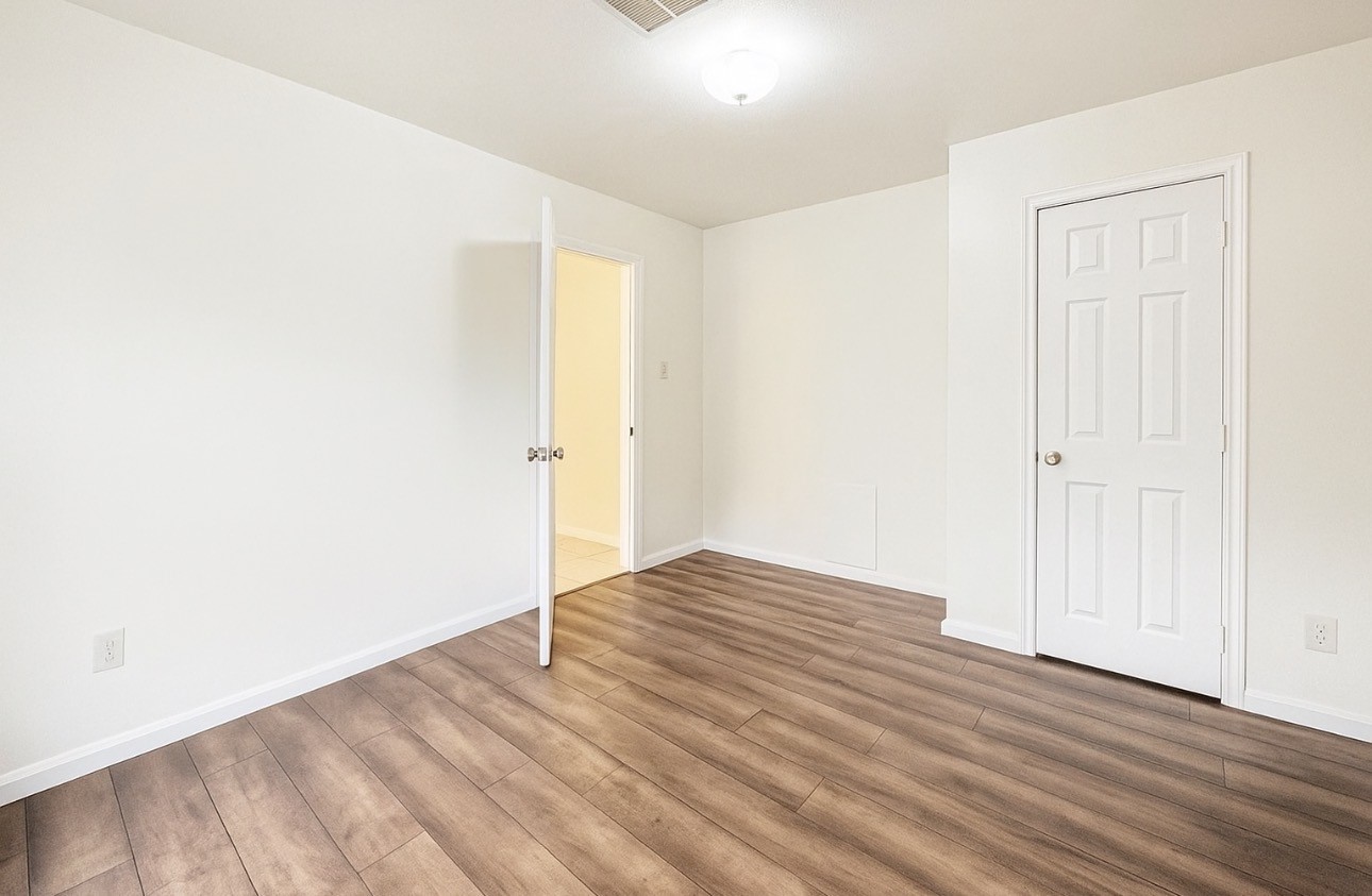 9811 Mango Street Houston, TX 77075 - Photo 3 of 14 an empty room with wooden floor and closet