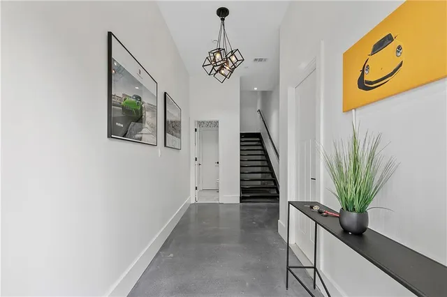 a hallway with a potted plant on a wall