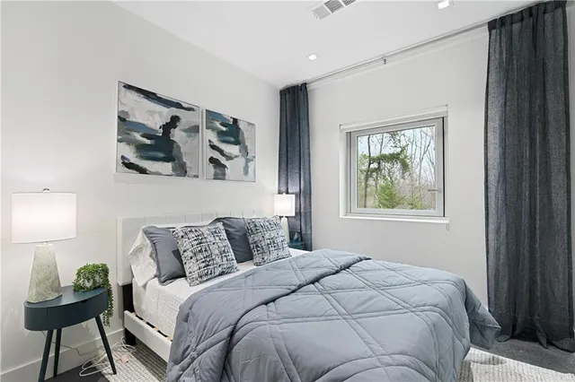 a bedroom with a bed and a lamp