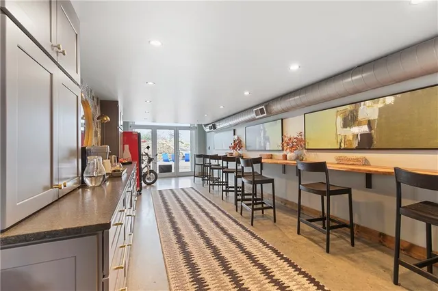 a view of a room with lots of furniture and wooden floor