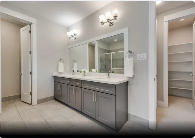 a bathroom with a double vanity sink and a mirror