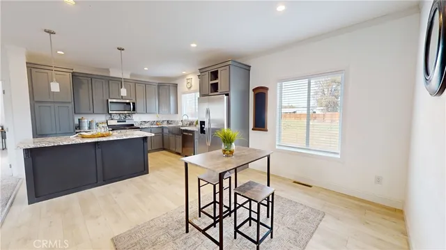 a living room with furniture potted plant and a table