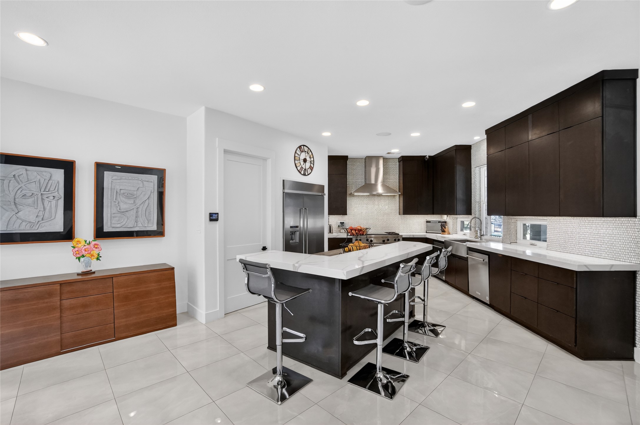 3627 Stoneridge Road, Unit 1 Austin, TX 78746 - Photo 11 of 39 Kitchen with a breakfast bar, modern cabinets, a center island, backsplash, and recessed lighting