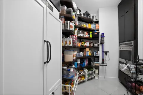 a spacious bedroom with a bed and a flat screen tv