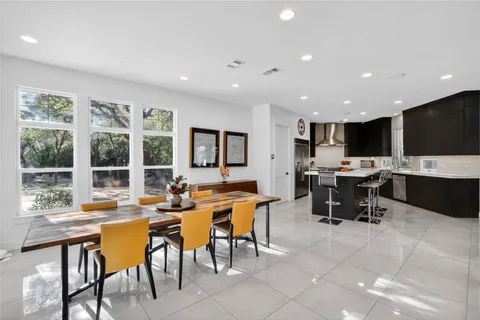 a view of a dining room with furniture and window