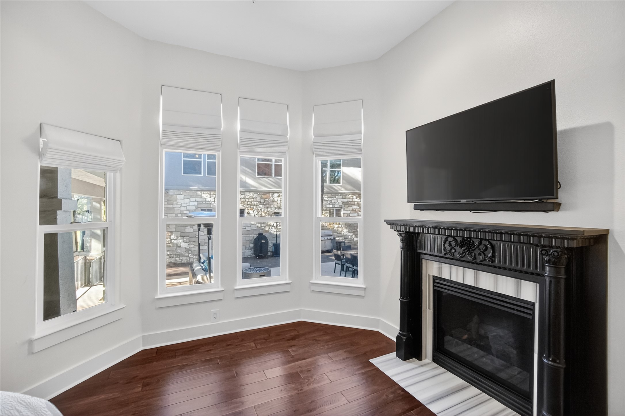 3627 Stoneridge Road, Unit 1 Austin, TX 78746 - Photo 16 of 39 Unfurnished living room with dark wood-style flooring and a fireplace with flush hearth