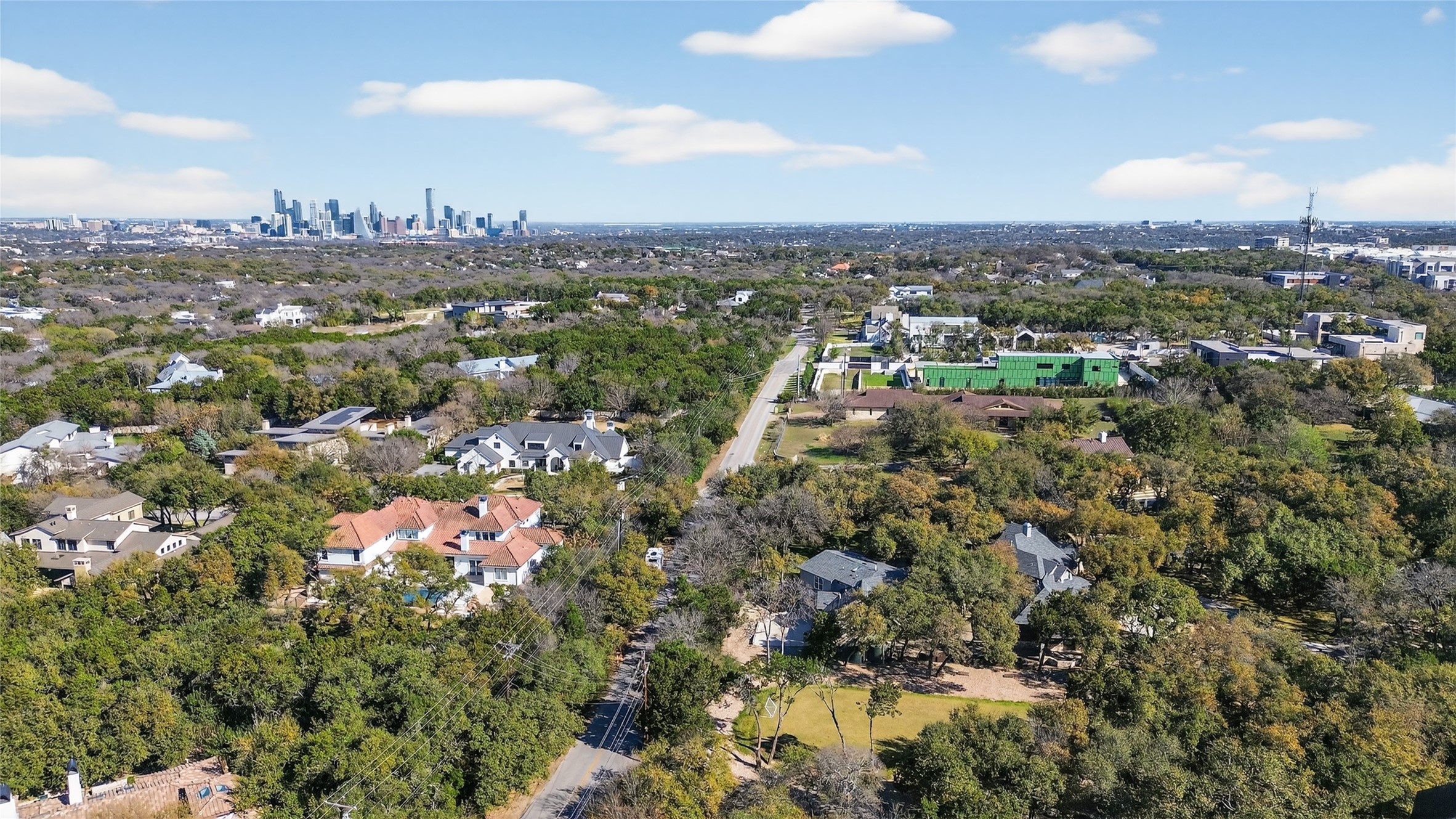 3627 Stoneridge Road, Unit 1 Austin, TX 78746 - Photo 2 of 39 Aerial perspective of suburban area featuring skyline and a tree filled landscape
