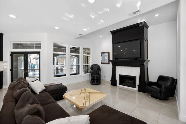 a living room with furniture a flat screen tv and a fireplace