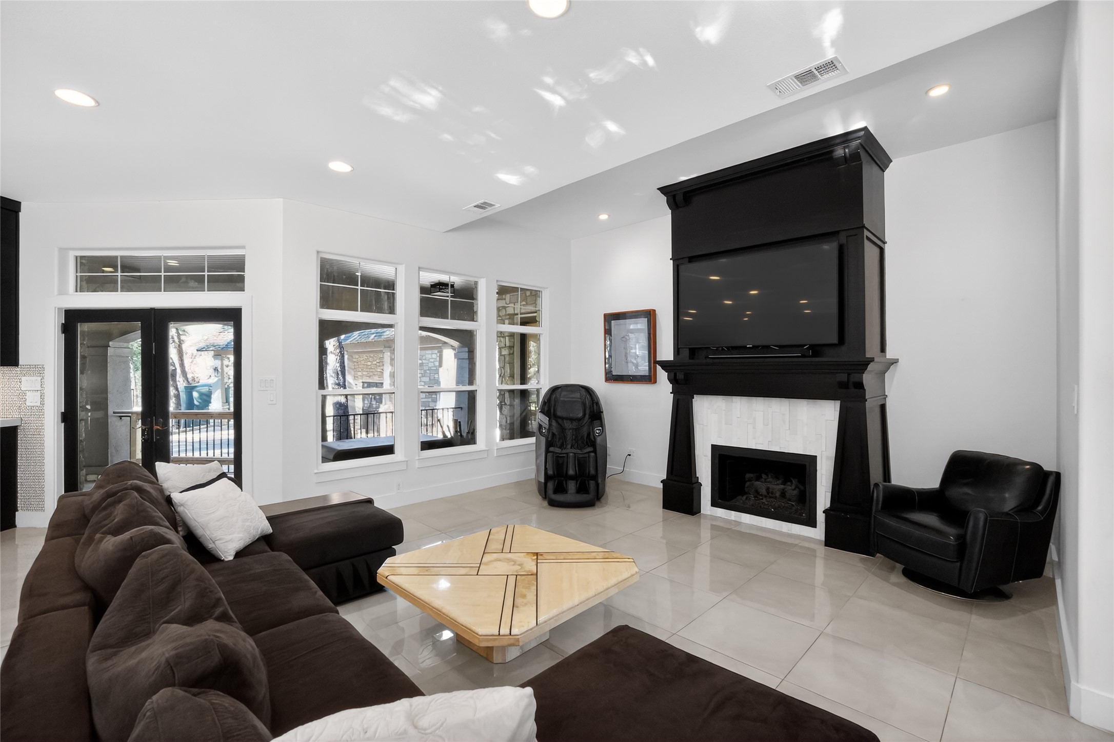 3627 Stoneridge Road, Unit 1 Austin, TX 78746 - Photo 6 of 39 Living room with a fireplace, recessed lighting, light tile patterned floors, and french doors