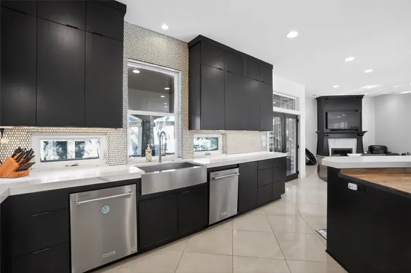 a kitchen with a sink and chairs