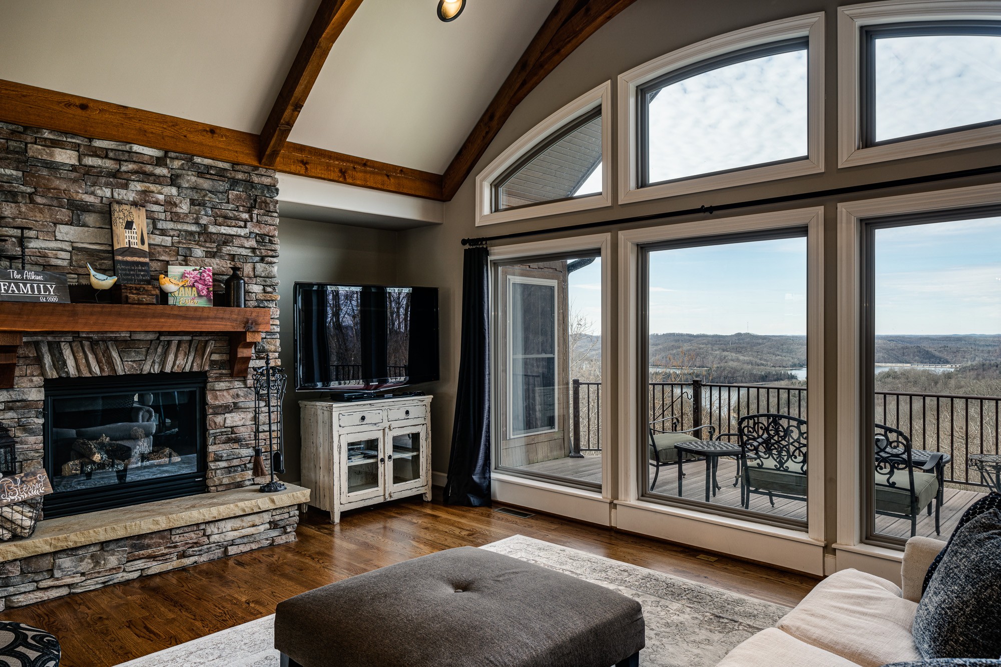 3639 Swan Ridge Road Celina, TN 38551 - Photo 3 of 37 a living room with furniture a flat screen tv and a fireplace