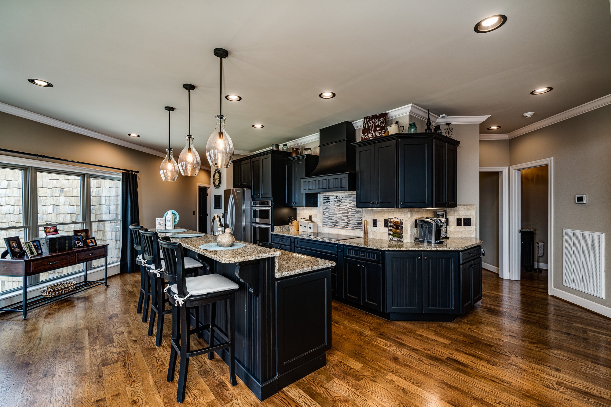 3639 Swan Ridge Road Celina, TN 38551 - Photo 8 of 37 a kitchen with stainless steel appliances kitchen island granite countertop a table and chairs in it