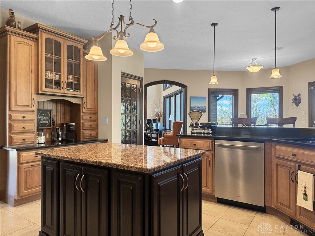 4096 Middle Urbana Road Urbana, OH 43078 - Photo 2 of 96 This kitchen features a central island, elegant lighting, and ample cabinetry for an inviting atmosphere.