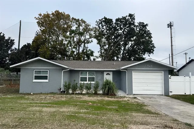 a front view of a house with a garden and yard